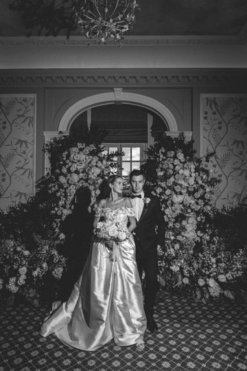 Bride and groom at elegant floral wedding venue